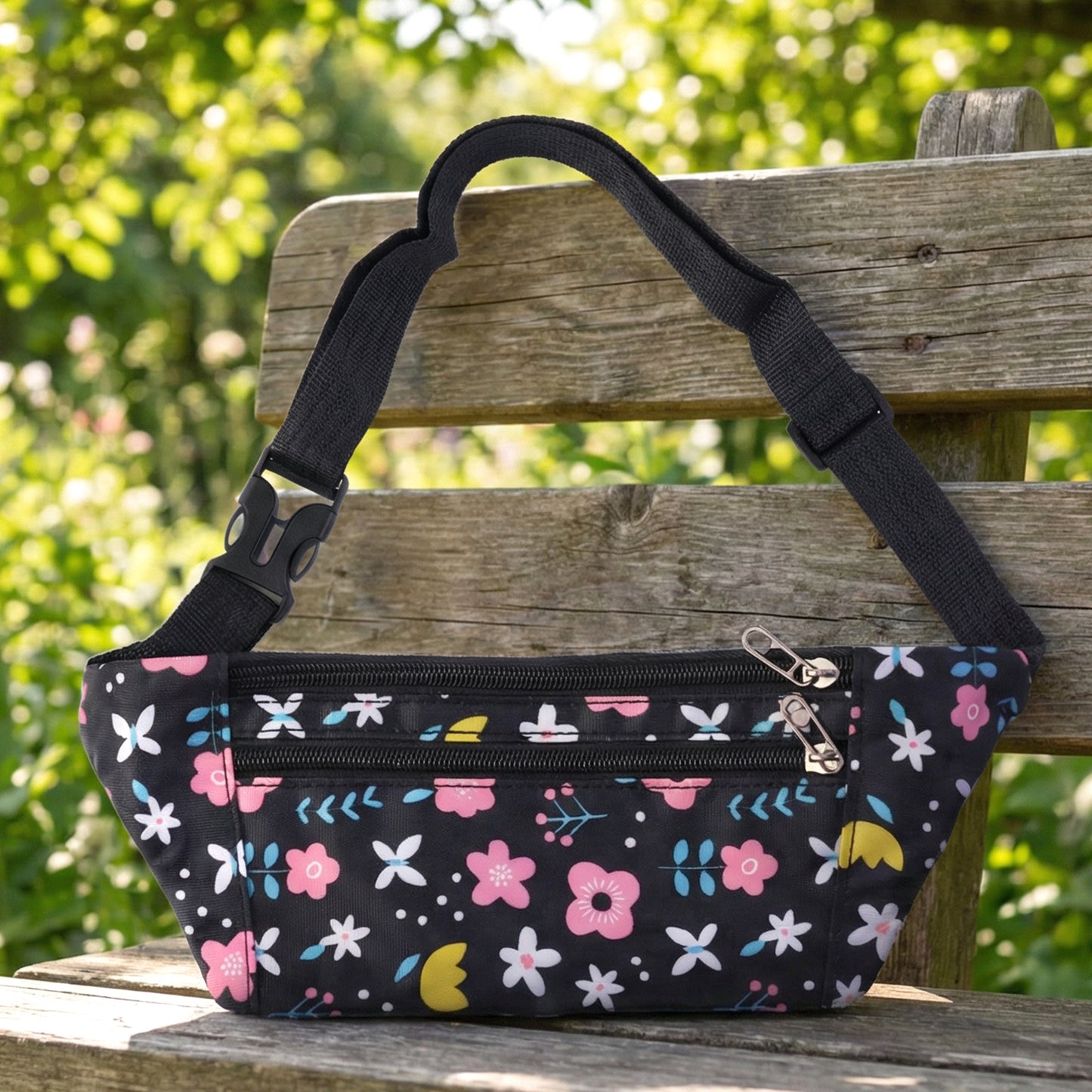 Wukusy floral print adjustable waist bag with zipper pocket, worn as a fanny pack, featuring colorful floral pattern and adjustable strap.