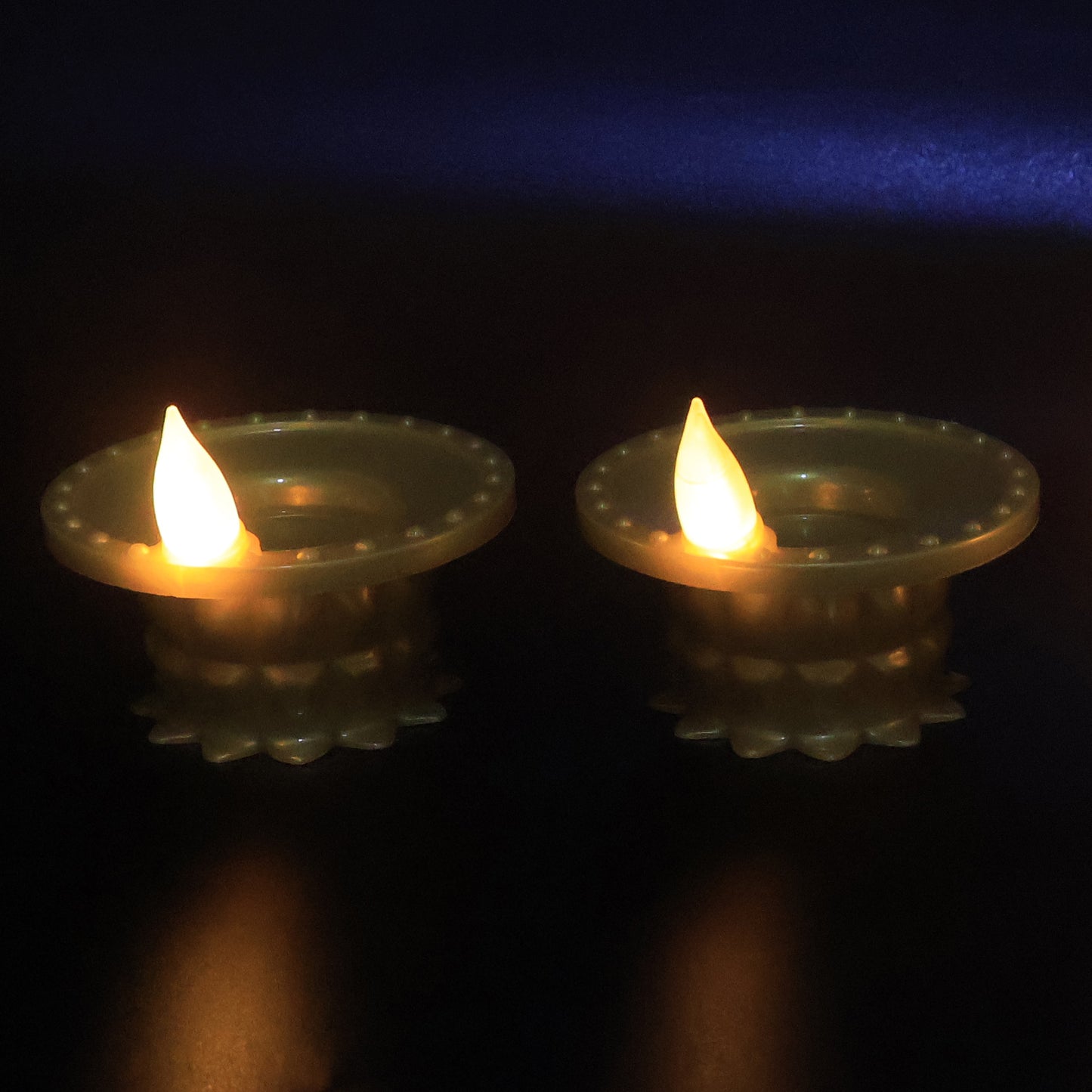 Set of 12 Wukusy water sensor LED golden diyas for home decor, featuring illuminated, decorative traditional Indian oil lamps.