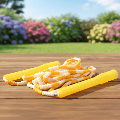 Yellow and white beaded skipping jump rope by Wukusy, shown coiled with beads visible and handles at each end.