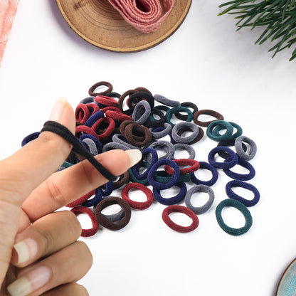 Pack of 50 multicolor Wukusy small hairbands made of rubber, perfect for securing hair comfortably and stylishly.