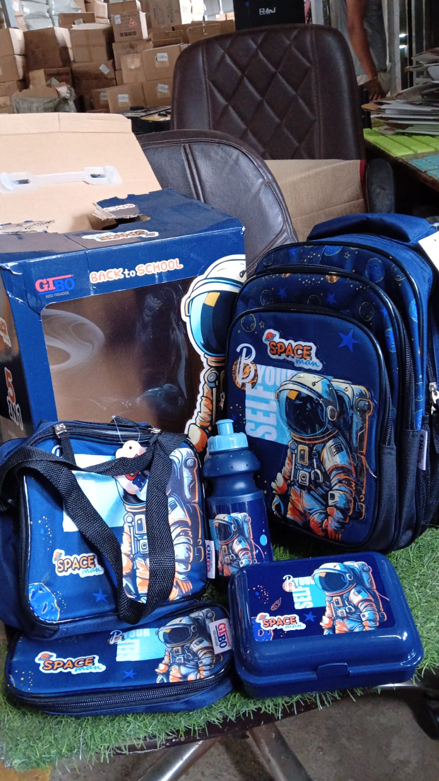 Wukusy 5-in-1 school bag set with 14-inch backpack, lunch bag, water bottle, and pencil case in mixed colors, in box packaging.