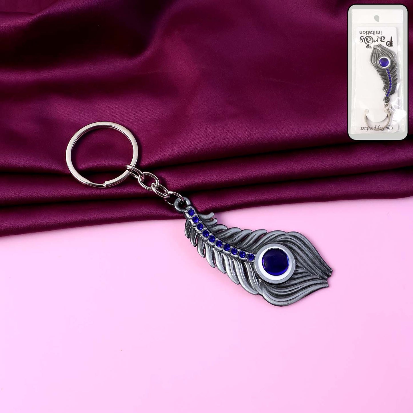 Elegant metal peacock feather keychain by Wukusy featuring detailed feather design on a sturdy keyring.