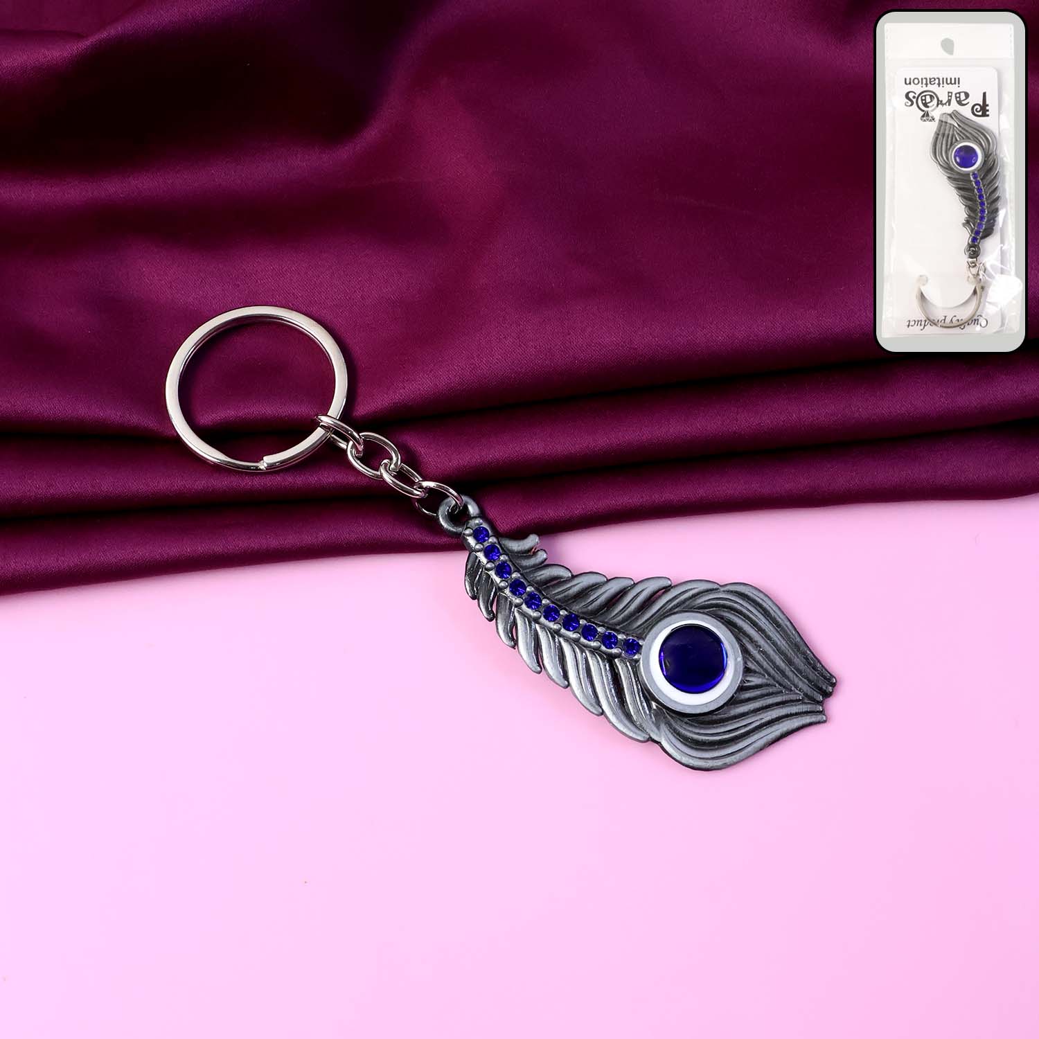 Elegant metal peacock feather keychain by Wukusy featuring detailed feather design on a sturdy keyring.