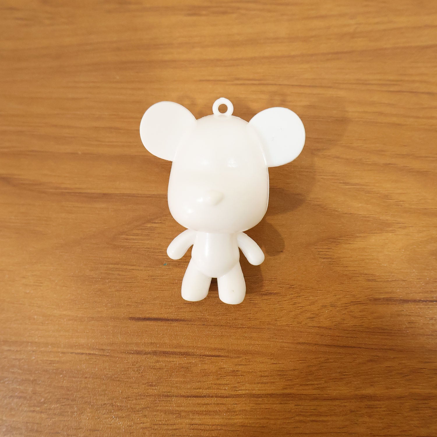 Wukusy cute bear figure keychain hanging from a keyring, featuring a plush, adorable bear design perfect for keys or bags.