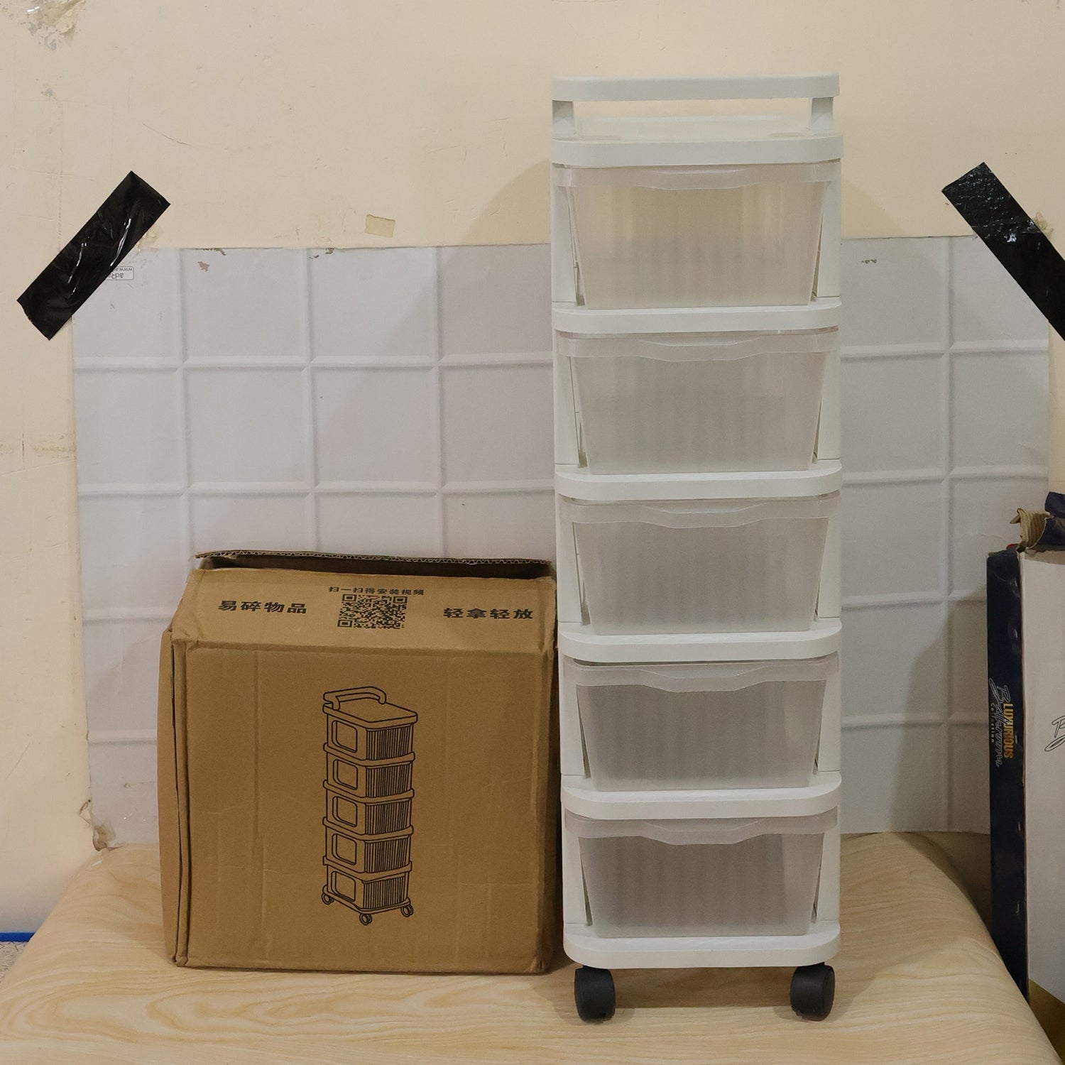Wukusy 5-layer plastic storage drawer rack with wheels, ideal for organizing home supplies with adjustable drawers and sturdy design.