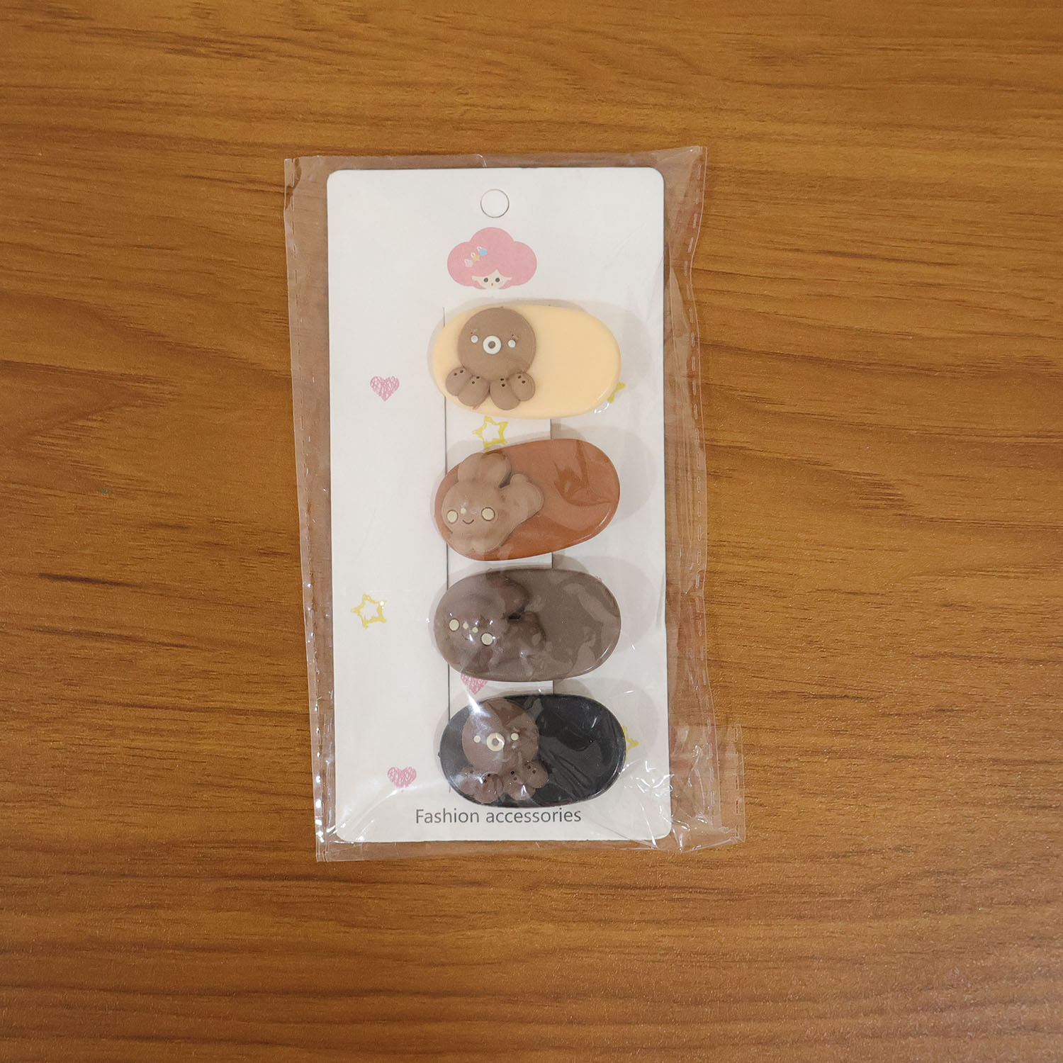 Set of four cute cartoon bear design hair clips by Wukusy, featuring playful bear faces and colorful styles for kids.
