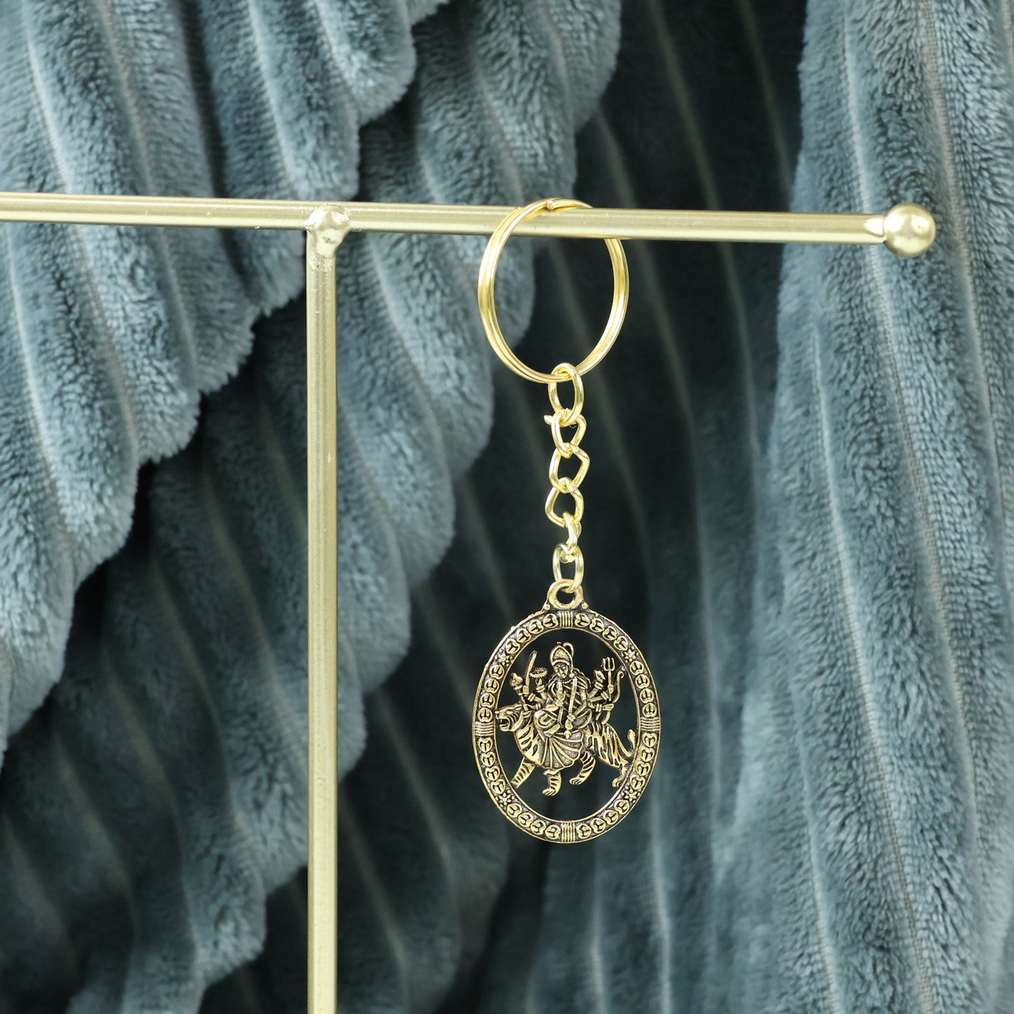 Golden Maa Durga oval frame keychain by Wukusy featuring a detailed image of the goddess on a compact keychain.