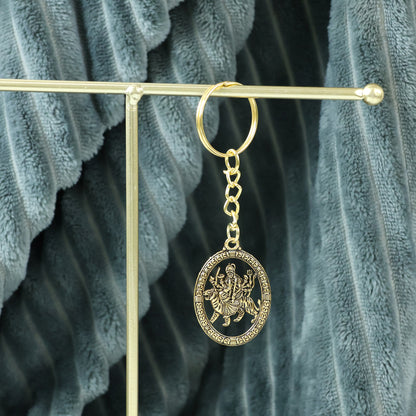 Golden Maa Durga oval frame keychain by Wukusy featuring a detailed image of the goddess on a compact keychain.