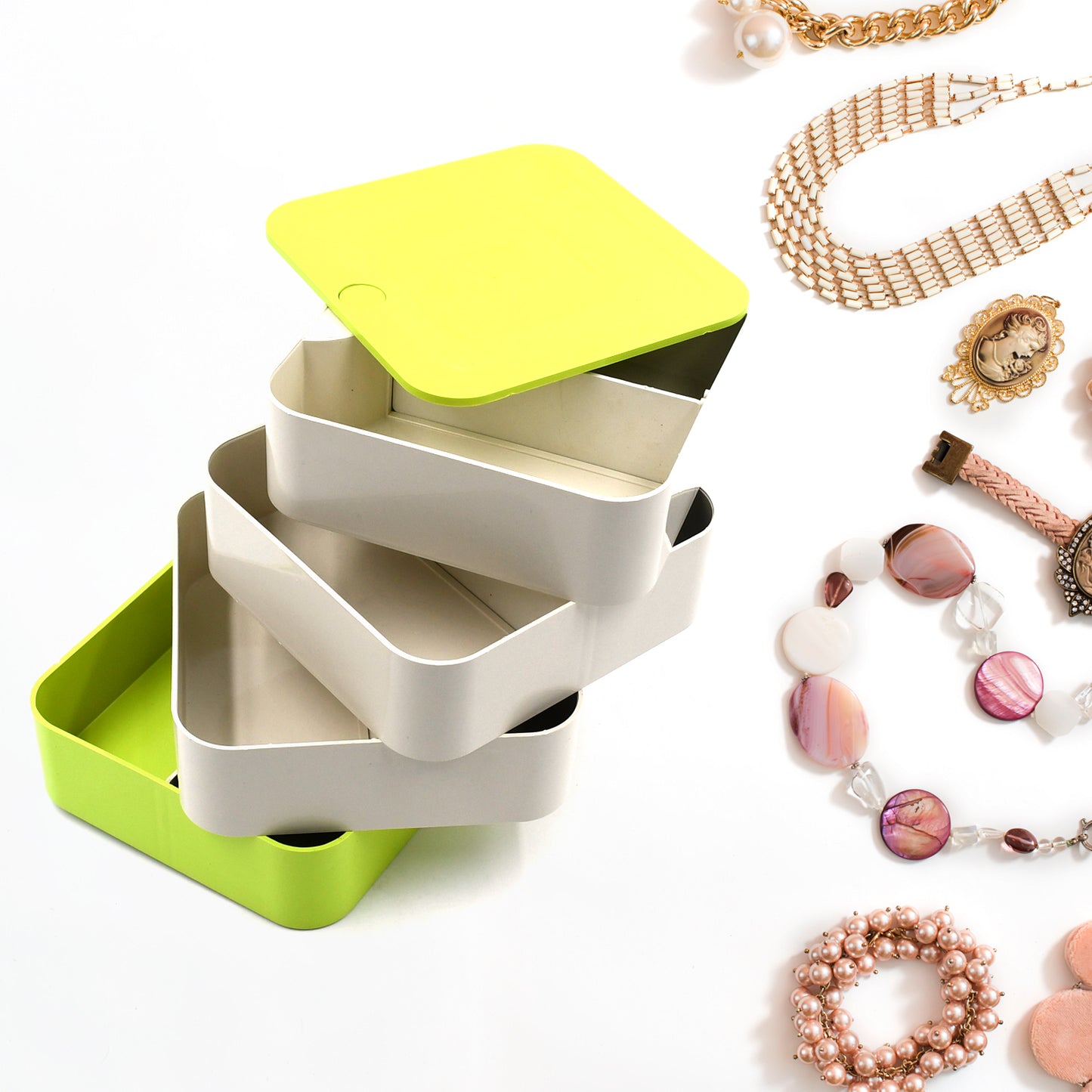 Wukusy 4700 4-layer jewelry box with 360-degree rotating design, holding earrings, necklaces, and accessories in a home organization style.