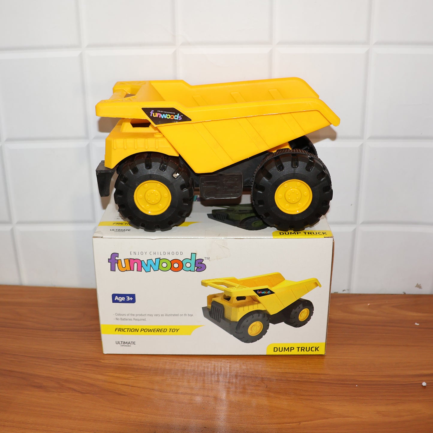 Wukusy Funwoods friction-powered dump truck toy with orange body and black wheels, designed for children’s play.
