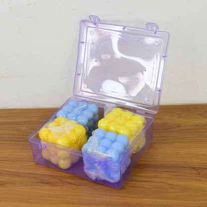 Set of four colorful cube-shaped wax candles by Wukusy for home decor, displayed together on a neutral surface.