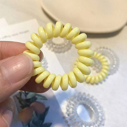 Colorful telephone wire hair band by Wukusy, featuring a mix of vibrant colors and flexible design for versatile styling.