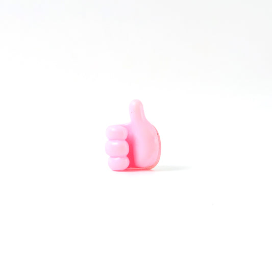 Pink multifunctional hand-shaped wall clip hanger by Wukusy for keys, cables, and small accessories, mounted on a wall.