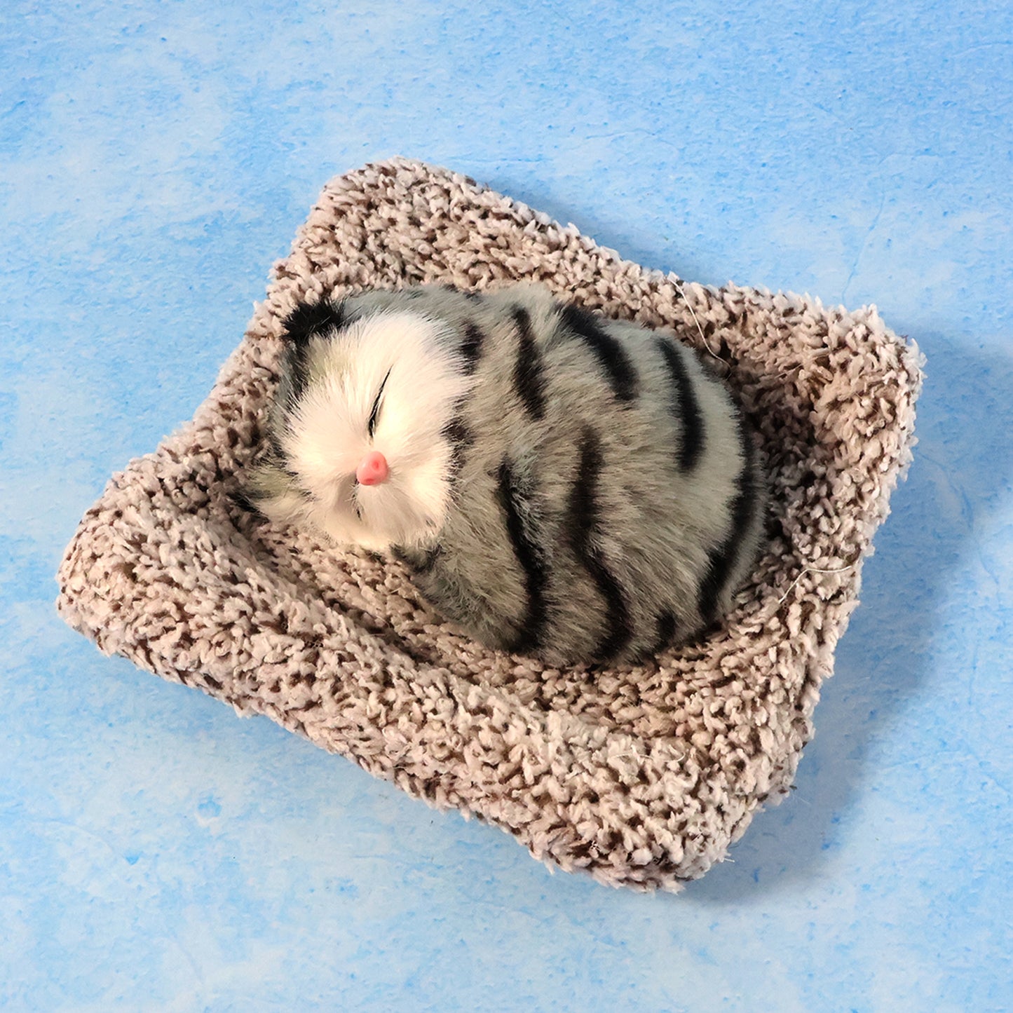 Soft plush Wukusy closed-eye cat dashboard toy, cute and cuddly car showpiece with detailed plush fabric and adorable facial features.
