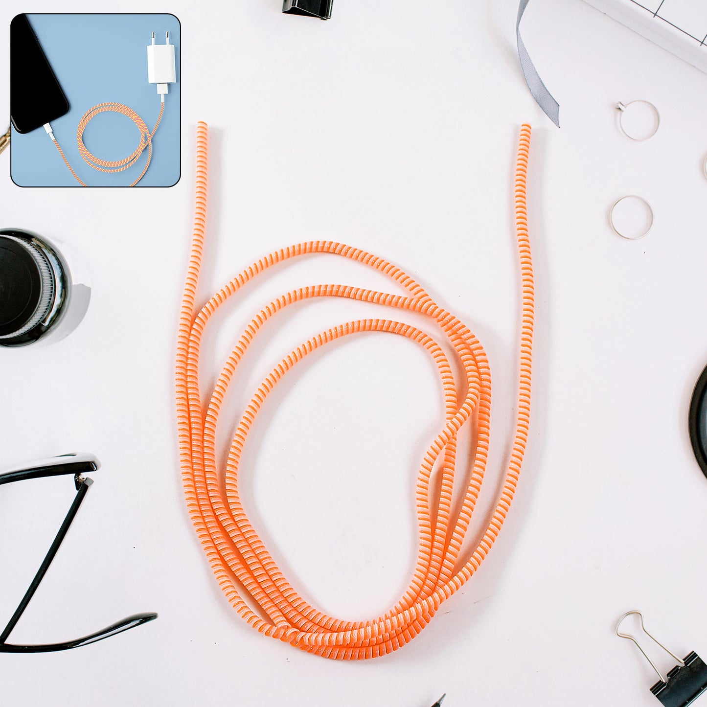 Flexible spiral cable protector sleeve by Wukusy for mobile accessories, shown coiled around a charging cable.
