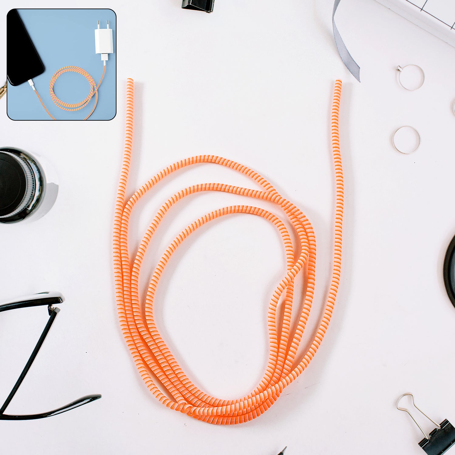 Flexible spiral cable protector sleeve by Wukusy for mobile accessories, shown coiled around a charging cable.