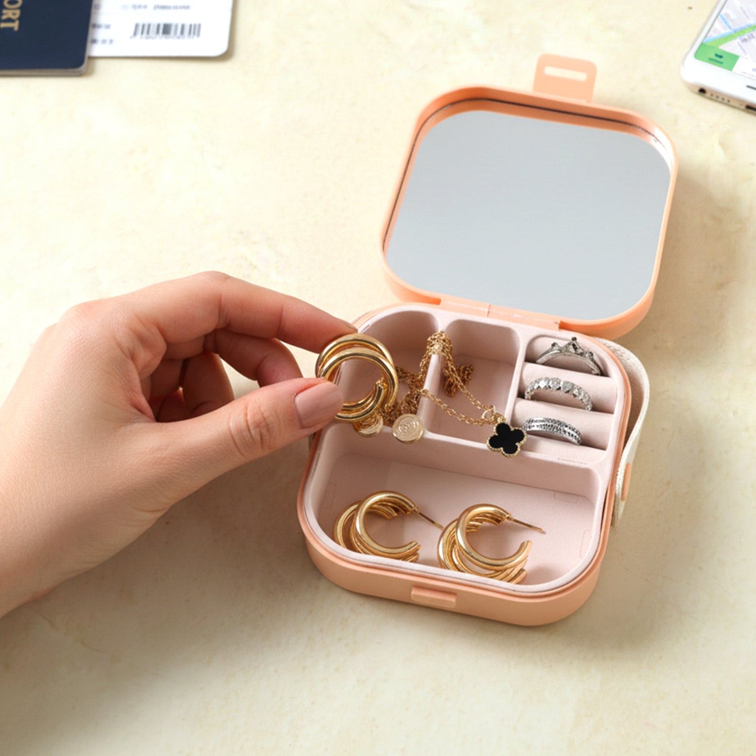 Compact Wukusy portable mini jewelry storage box with multiple compartments for organizing rings, earrings, and small jewelry pieces.
