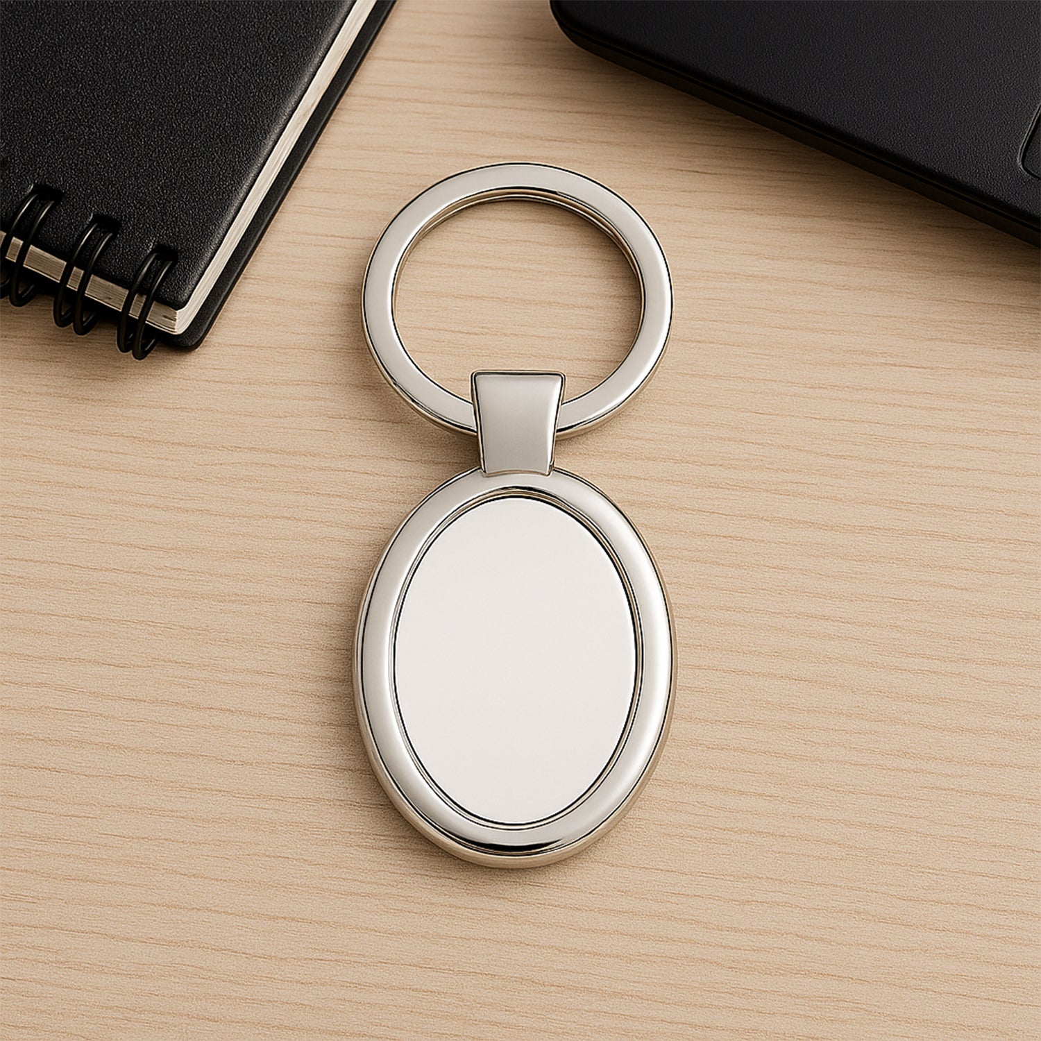 Elegant oval-shaped metal keychain by Wukusy with a polished finish and a sturdy keyring for personal use.