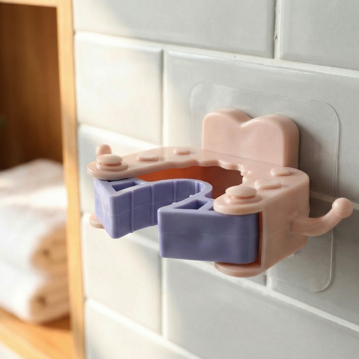Set of four Wukusy wall-mounted broom and mop holder clips attached to a wall for organizing cleaning tools.