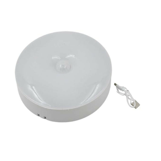 Wukusy rechargeable motion sensor LED night light with USB charging, illuminated with soft light in a dark room setting.