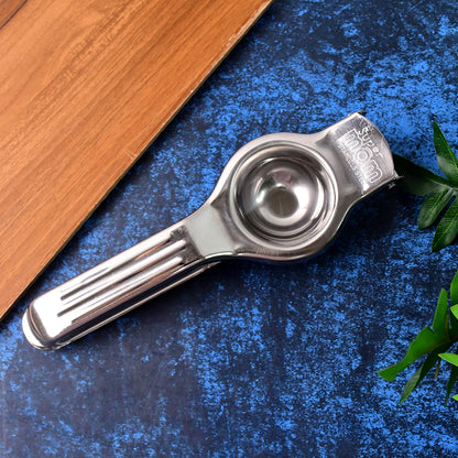 Wukusy Supermom 2-in-1 stainless steel lemon squeezer with built-in bottle opener in a home kitchen setting.