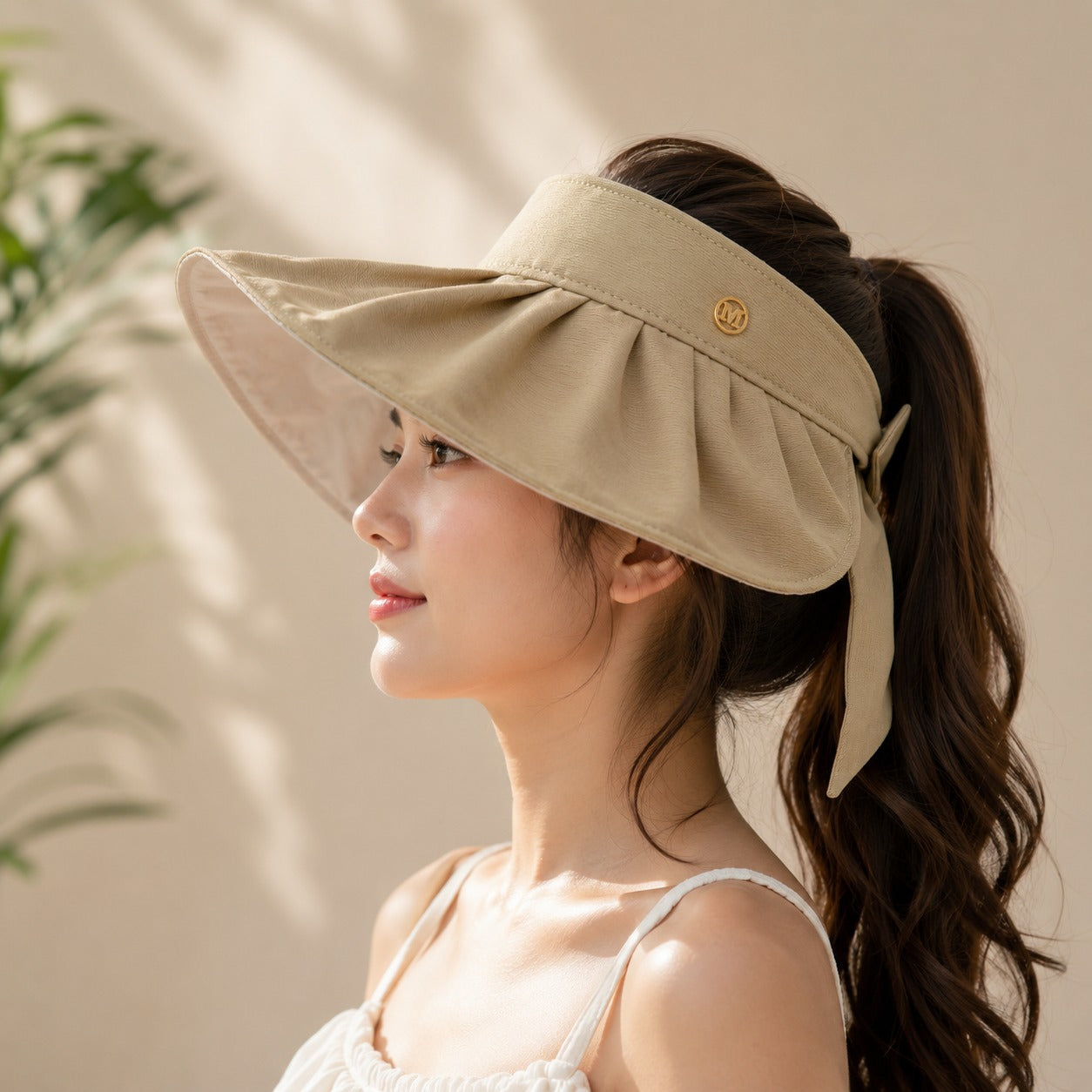 Wukusy women’s wide brim sun visor cap with adjustable strap, perfect for summer, in a random color, shown on a model.