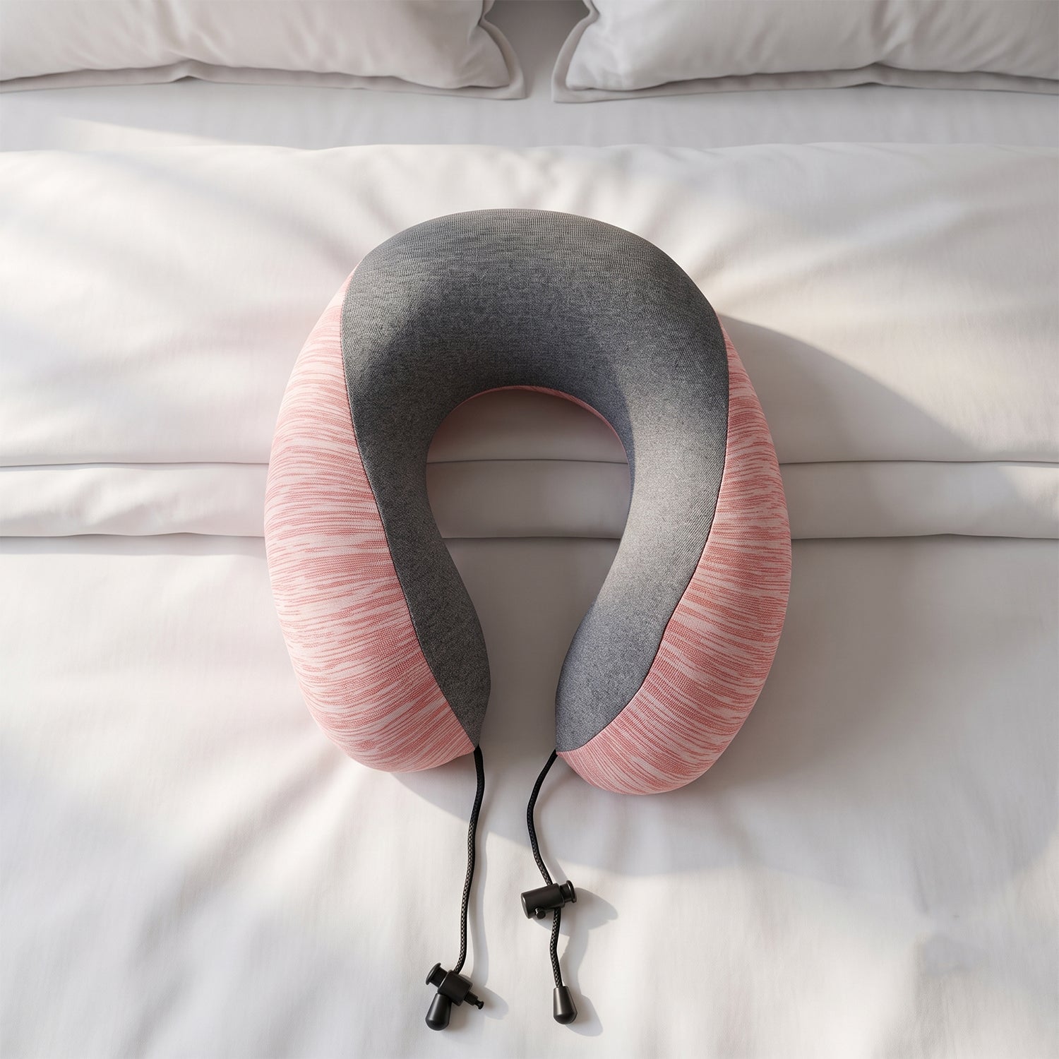Pink and grey U-shaped travel neck pillow with drawstring toggle by Wukusy, designed for comfortable neck support during travel.