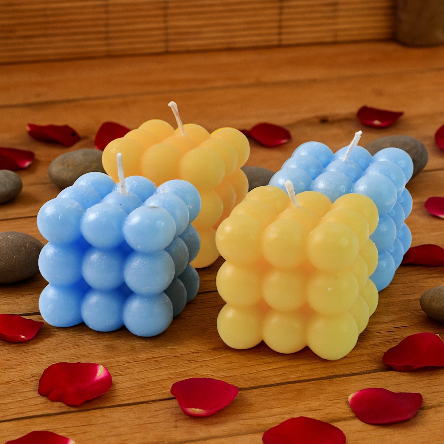 Colorful cube-shaped wax candles by Wukusy, set of 4, used as stylish home decor accents.
