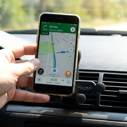 Wukusy universal car air vent mobile phone holder mounted on car vent, holding a smartphone securely for easy access while driving.