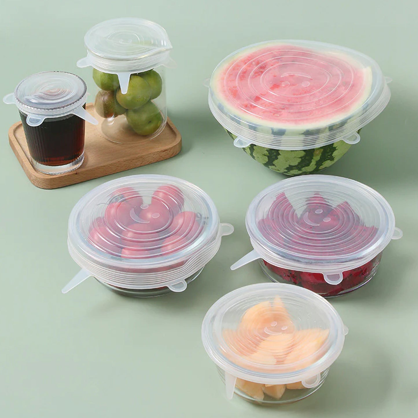 Six reusable stretchable food covers in assorted sizes, Wukusy brand, shown covering bowls and containers for fresh food storage.