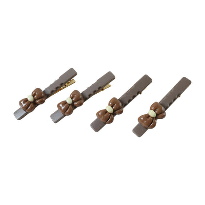 Set of four Wukusy elegant bow design decorative hair clips with stylish, feminine accessories for hair styling.