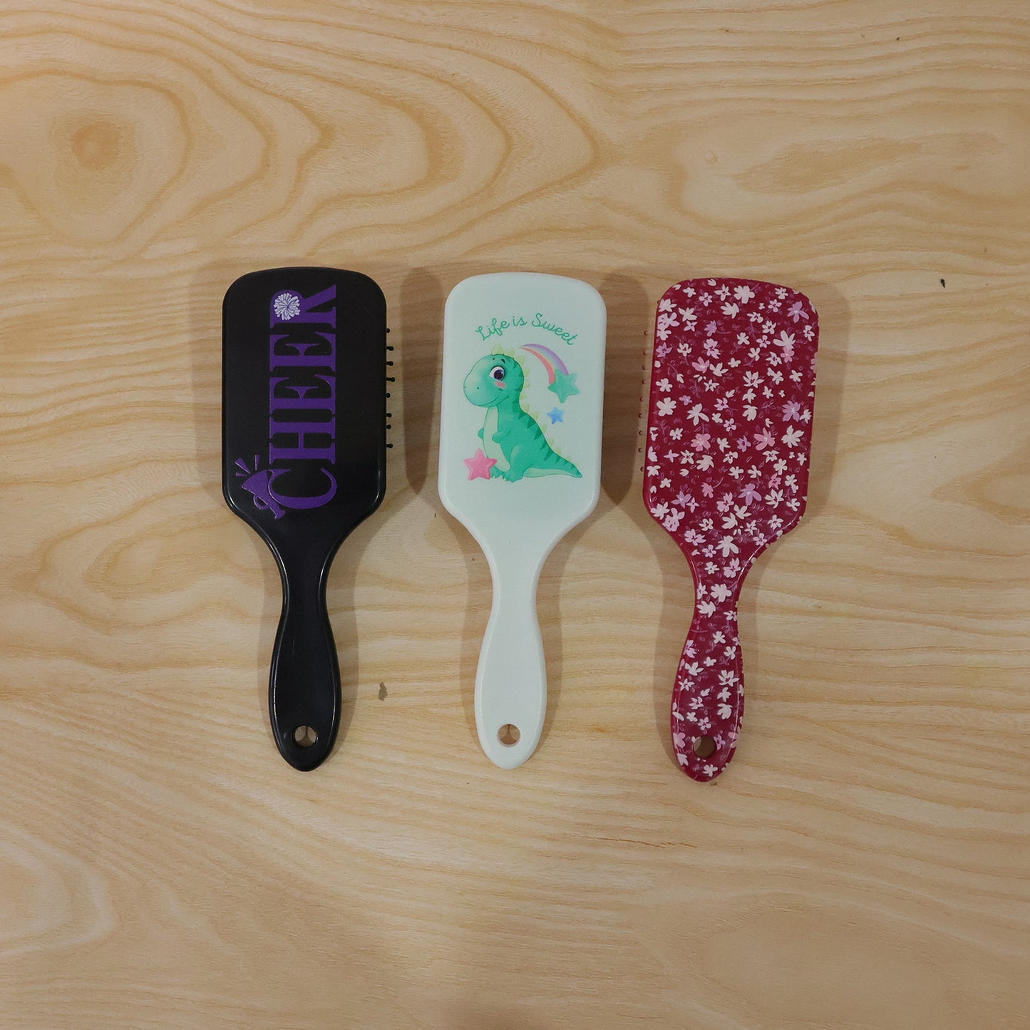 Colorful Wukusy kids hair brush with fun mixed designs, suitable for children, featuring soft bristles and playful patterns.