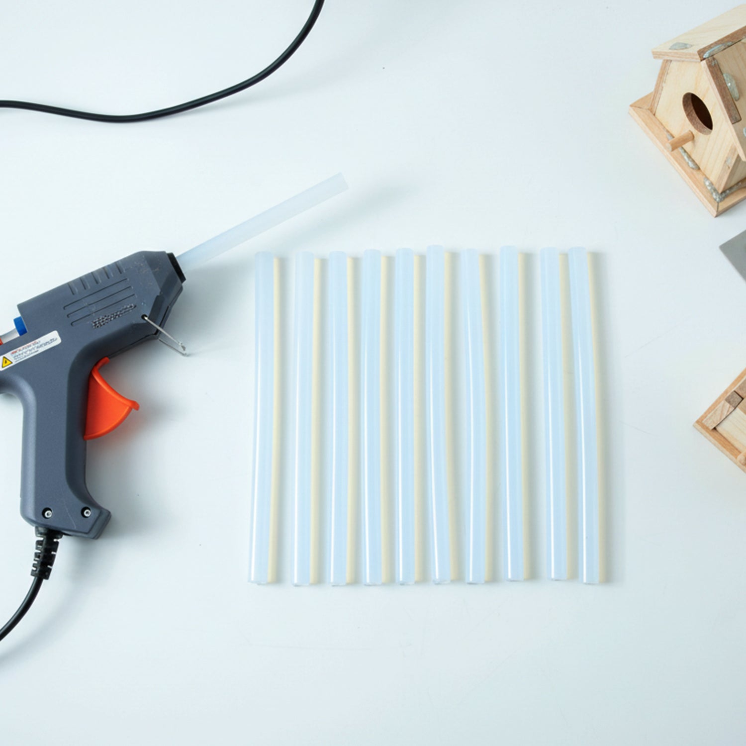 Set of 10 Wukusy hot glue sticks, 20 cm long, strong adhesive for crafts, displayed in a clear container.