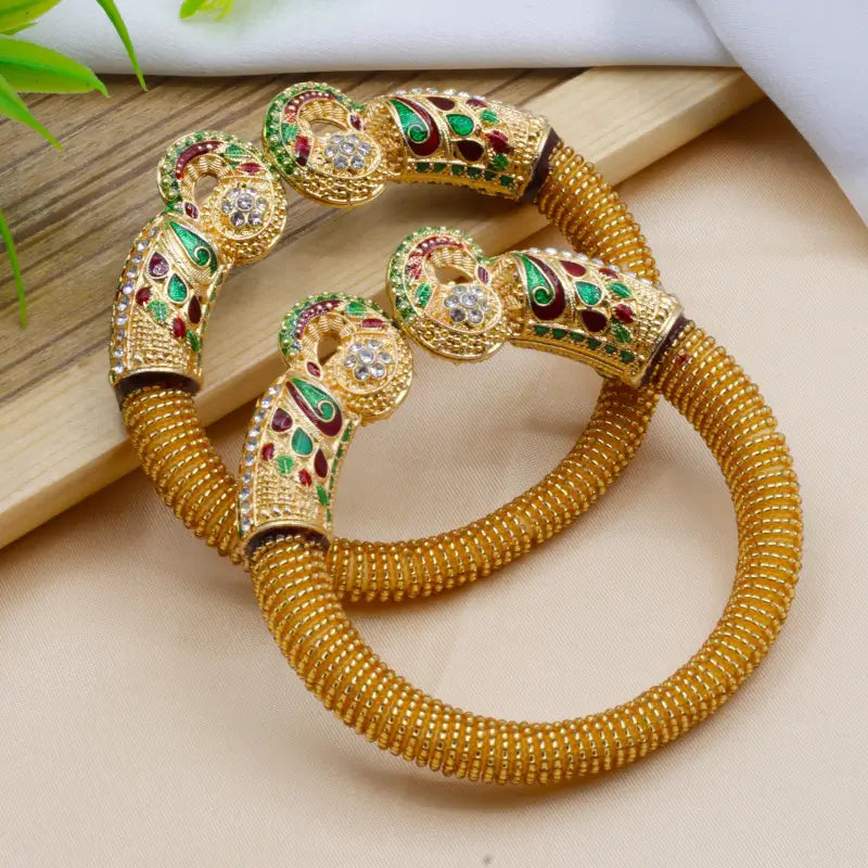 Elegant traditional peacock design pearl bangles for women by Ekom, featuring intricate peacock motifs and pearl embellishments.