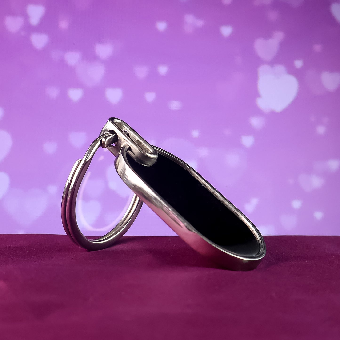 Elegant black and silver oval metal keychain by Wukusy, featuring a sleek design and polished finish.