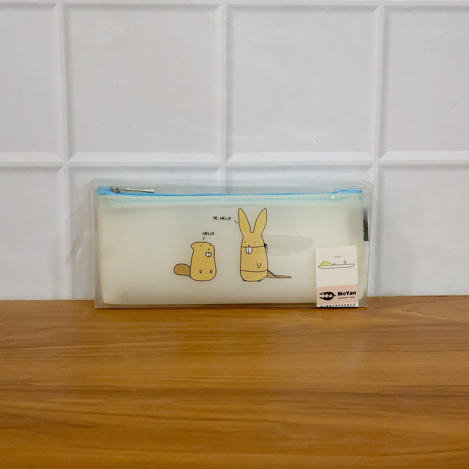 Transparent cartoon pencil pouch by Wukusy with cute animal design, showing its clear plastic material and zipper closure.