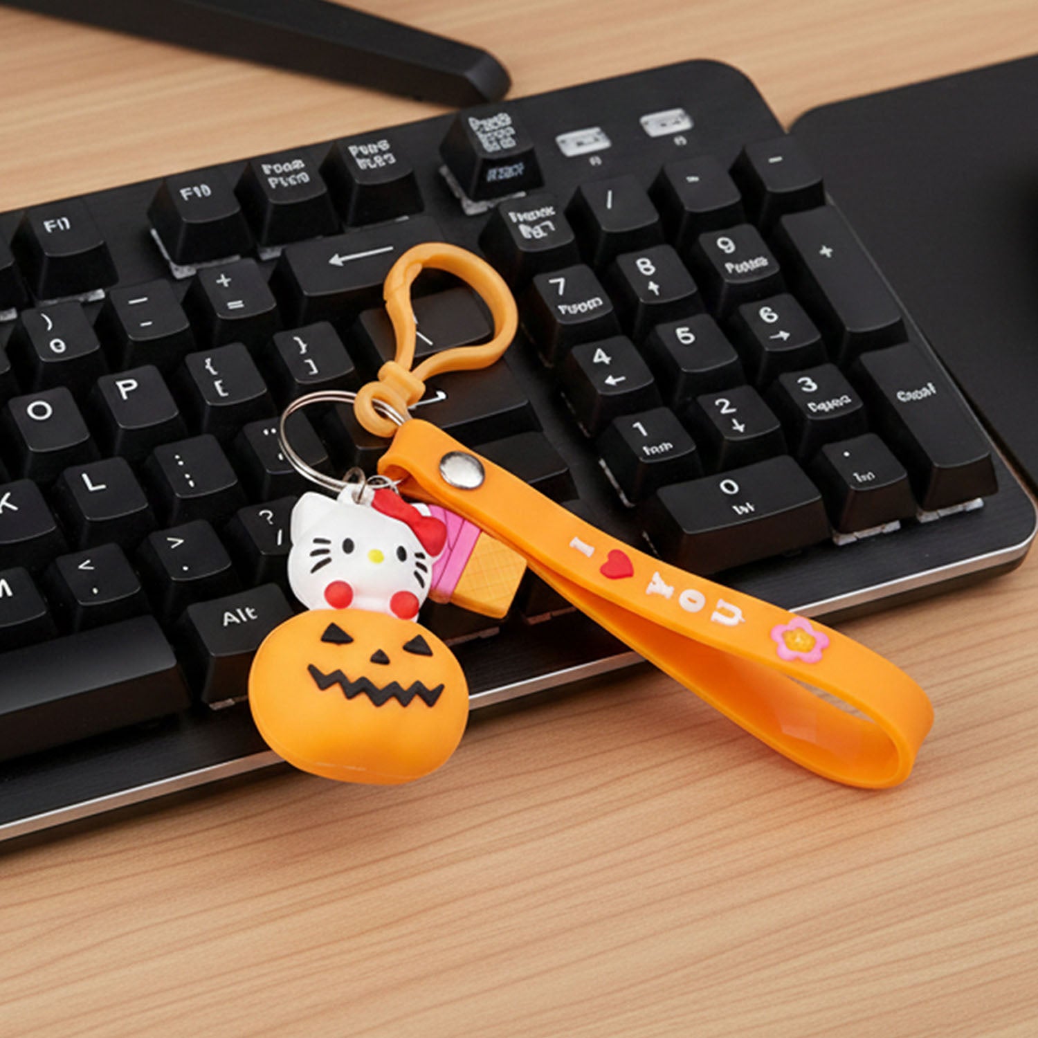 Cute cartoon kitty pumpkin keychain by Wukusy featuring a adorable cat design with a pumpkin shape and vibrant colors.