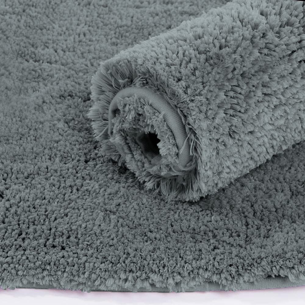 Grey Seasons bath mat for bathroom or door, soft and absorbent, shown laid out on a bathroom floor.