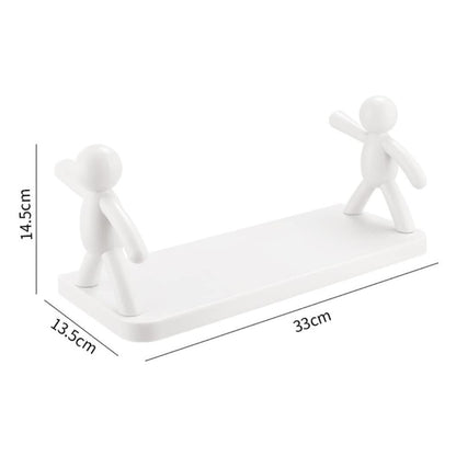 Wukusy 9271b self-adhesive floating wall shelf with a human figurine design, mounted on a brown box for home organization.