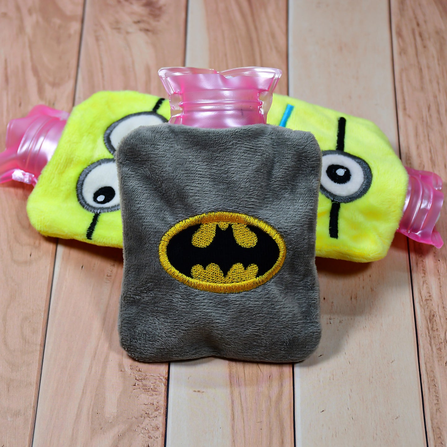 Wukusy 6505 Batman hot water bag with cover, showing a small, black bag designed for pain relief and warmth for neck, shoulders, hands, and feet