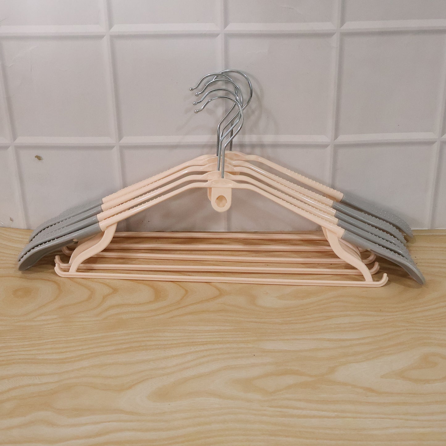 Set of five durable plastic clothes hangers by Wukusy, featuring smooth edges and sturdy design for clothing organization.