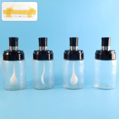 Set of four transparent Wukusy spice jars with airtight lids and spoons for kitchen storage, shown with spices inside.