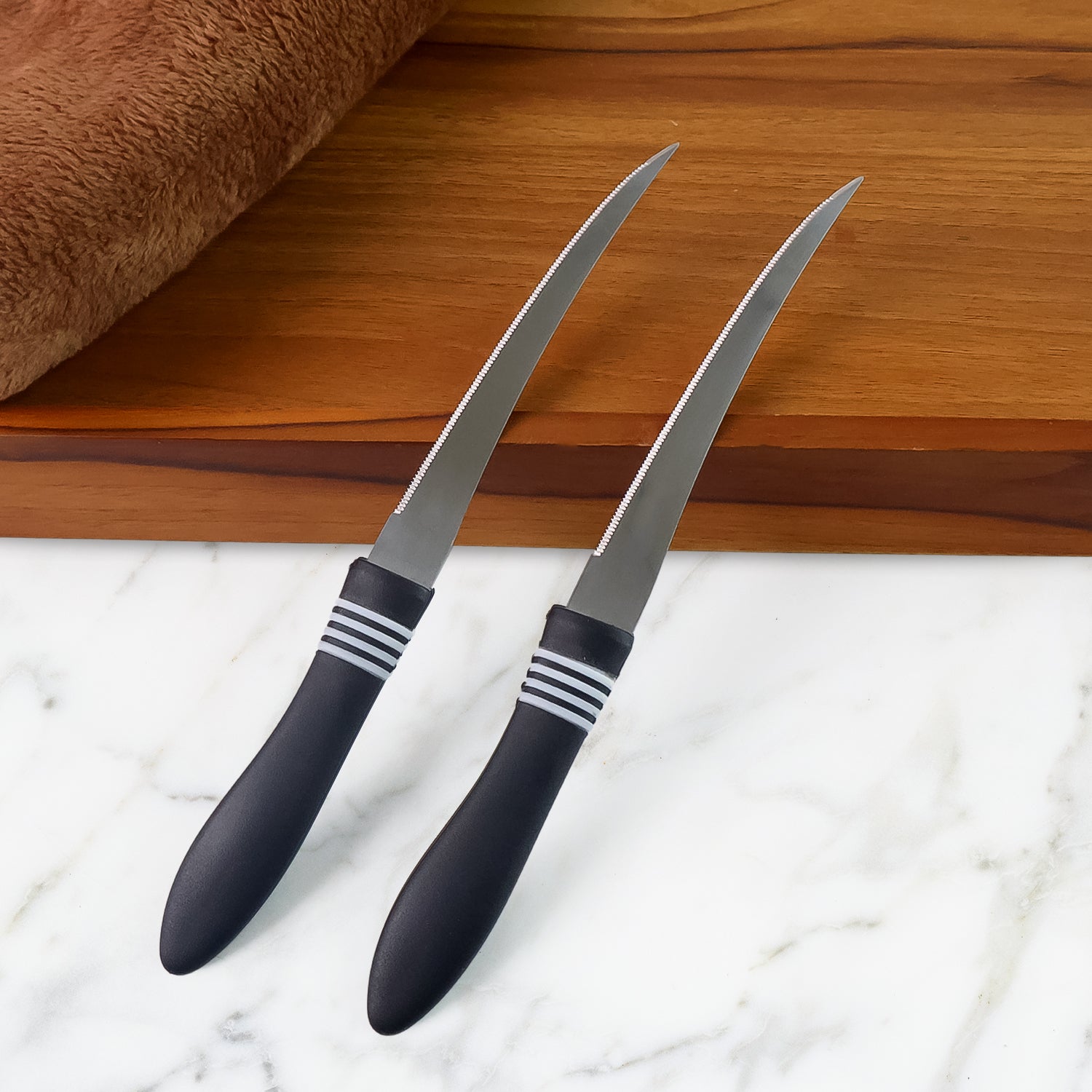 Wukusy premium curved serrated stainless steel kitchen knife set with two colorful knives on a cutting board.