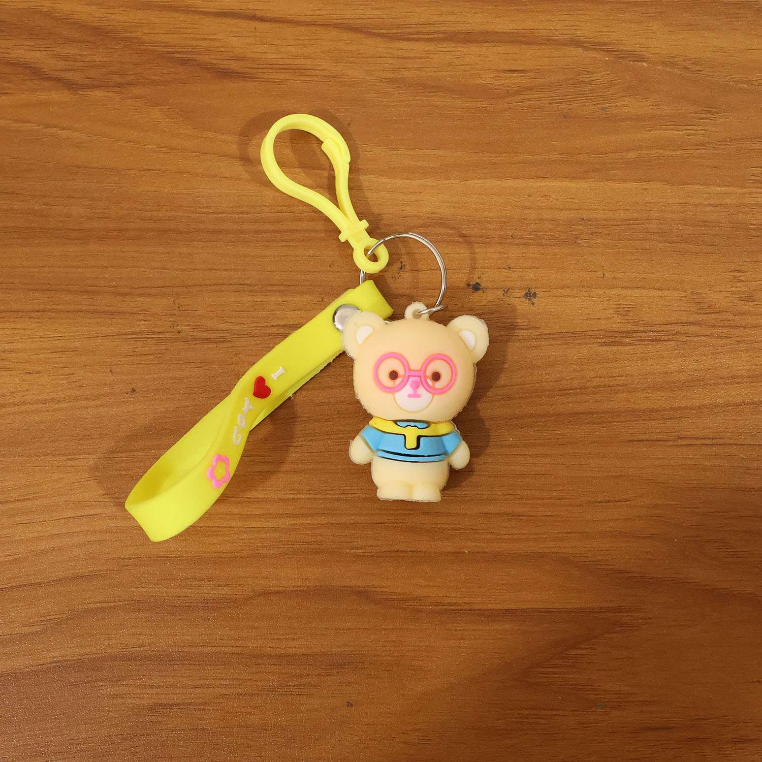 Cute cartoon bear silicone keychain by Wukusy, featuring a colorful bear design on a keyring.