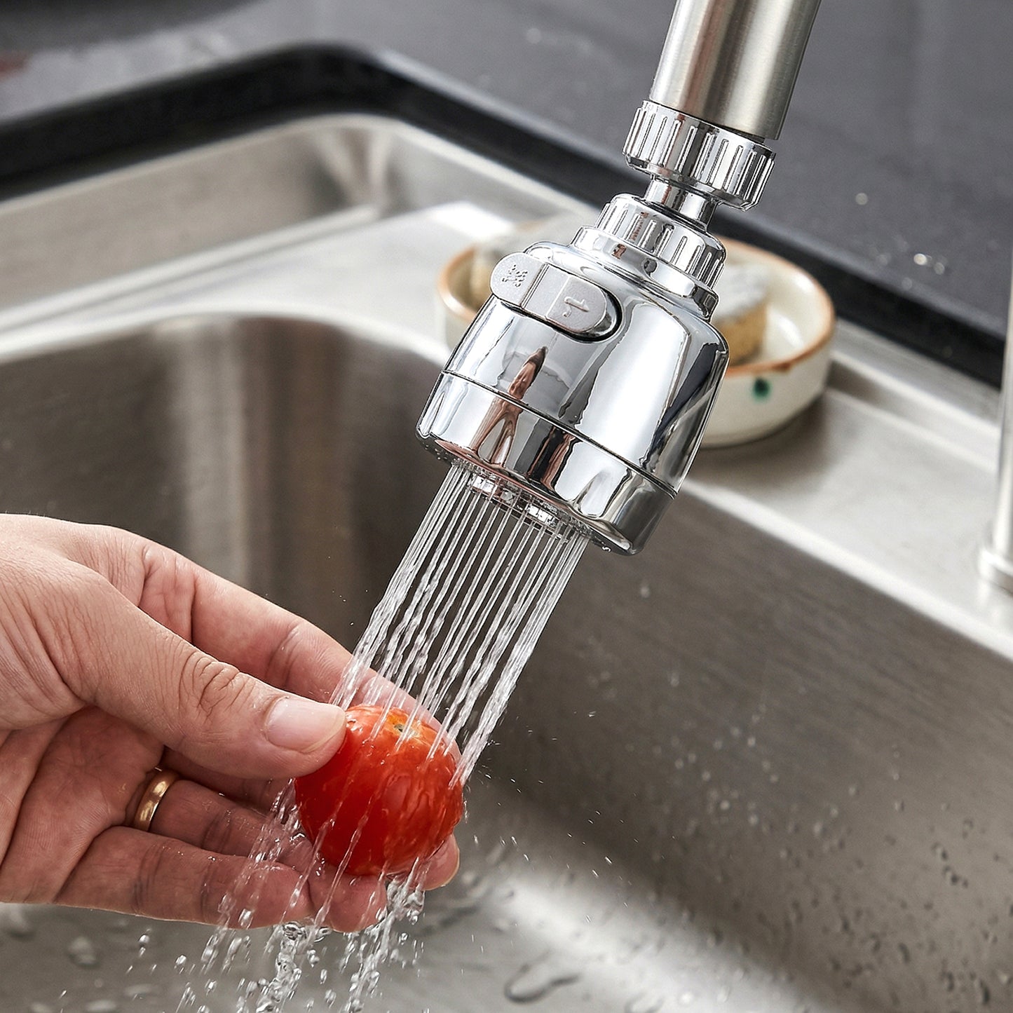 Wukusy 360-degree rotating faucet water-saving tap aerator set installed on kitchen sink faucet, demonstrating adjustable water flow.