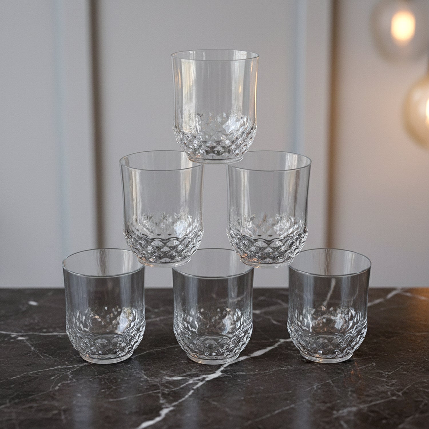 Six transparent Wukusy drinking glasses with diamond-pattern design, perfect for casual or formal beverage servings.