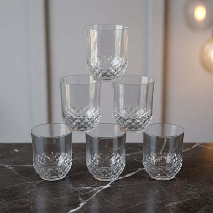 Six transparent Wukusy drinking glasses with diamond-pattern design, perfect for casual or formal beverage servings.