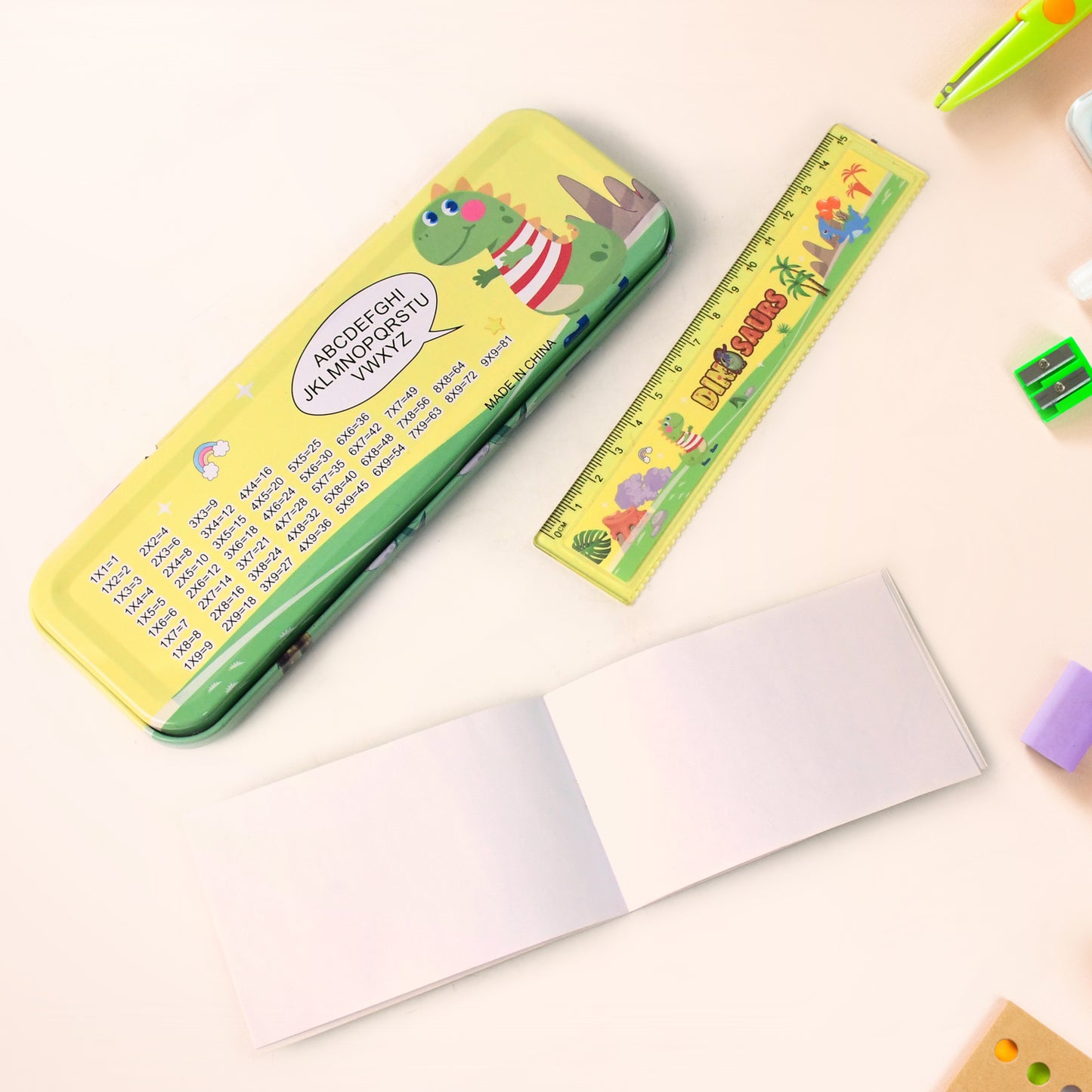 Colorful dinosaur printed kids stationery set by Wukusy, featuring notebooks, pens, and stickers with playful dinosaur designs.
