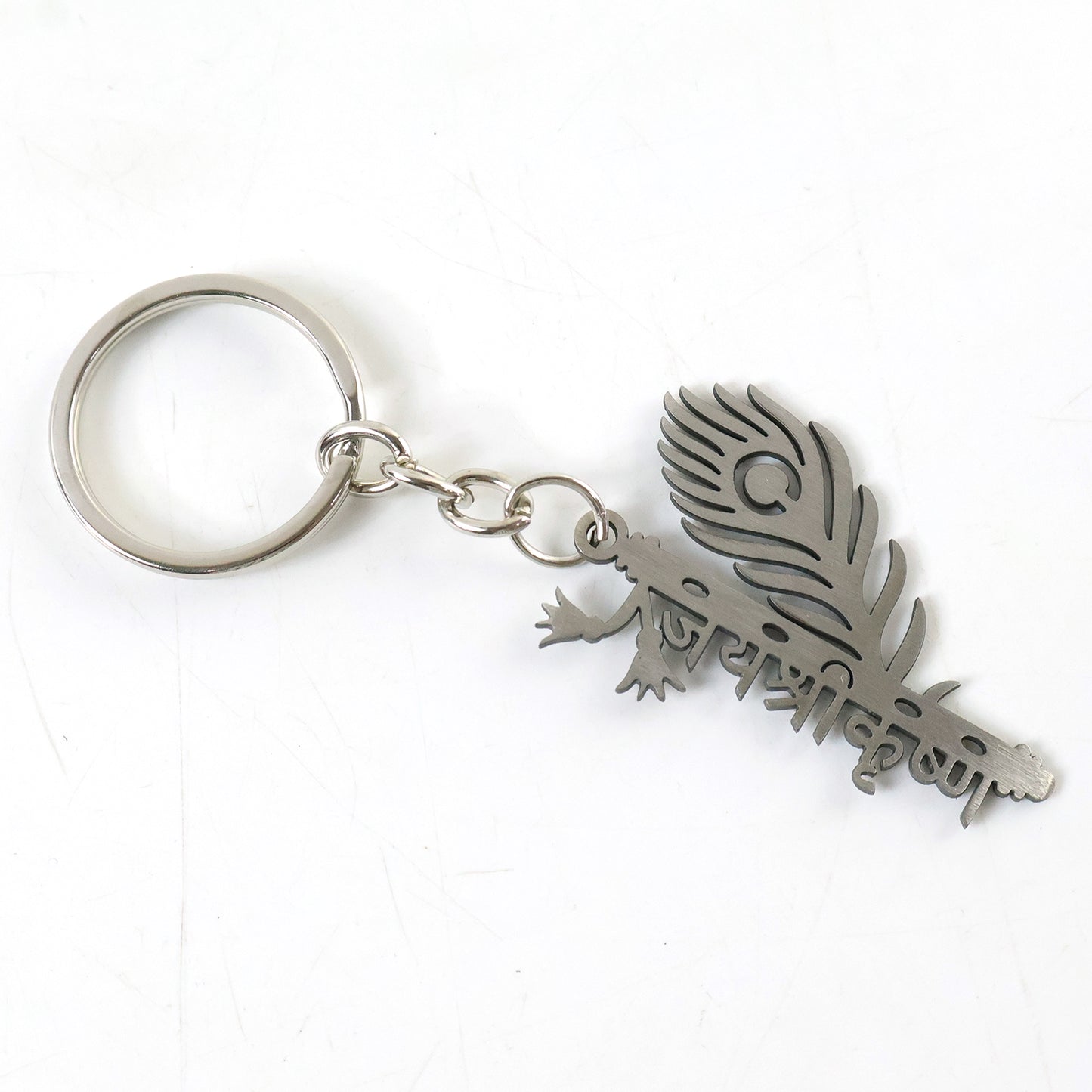 Metal flute Krishna keychain by Wukusy featuring a detailed miniature flute and Krishna figure on a keyring.