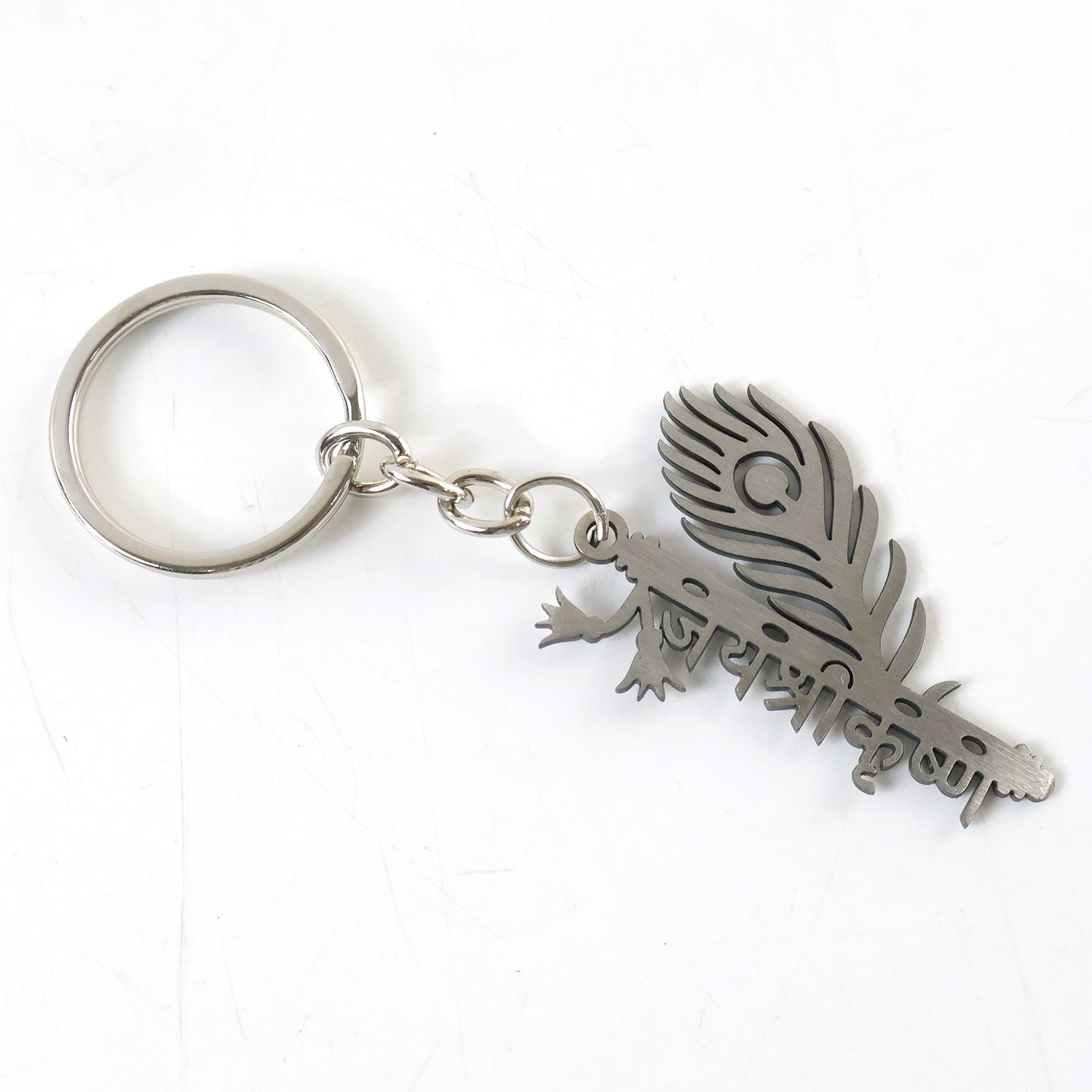 Metal flute Krishna keychain by Wukusy featuring a detailed miniature flute and Krishna figure on a keyring.